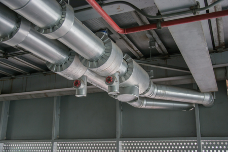 cables and piping as found inside of a thermal powerの写真素材