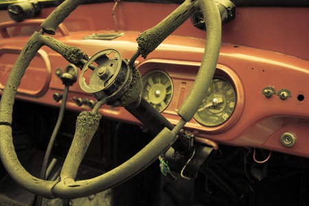 Steering wheel and dashboard in interior of old retro automobile. Processed by vintage or retro...