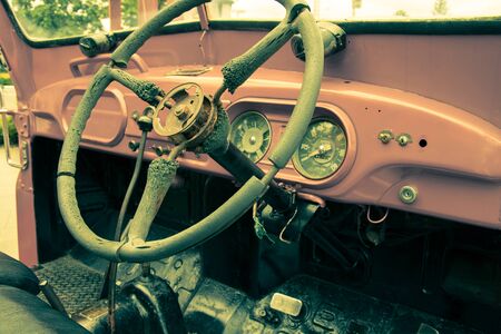 Steering wheel and dashboard in interior of old retro automobile. Processed by vintage or retro effect filterの写真素材