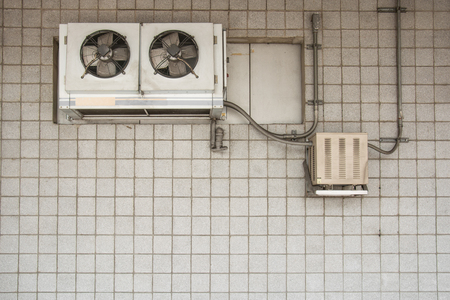 air compressor on the vintage brick wallの写真素材