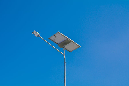 LED street light with solar cell on clear sky, closeup view.