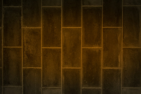 the Dark room with tile floor and brick wall backgroundの写真素材