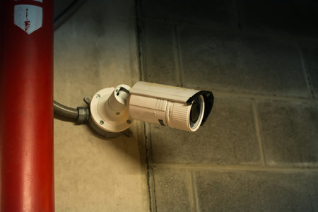 Security CCTV camera at ceiling in office building.Intelligent cameras can record video both day and...