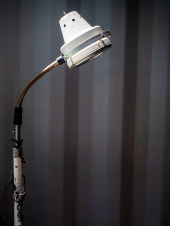 the old white desk lamp on black background