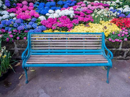 table and chairs standing on a lawn at the gardenの写真素材
