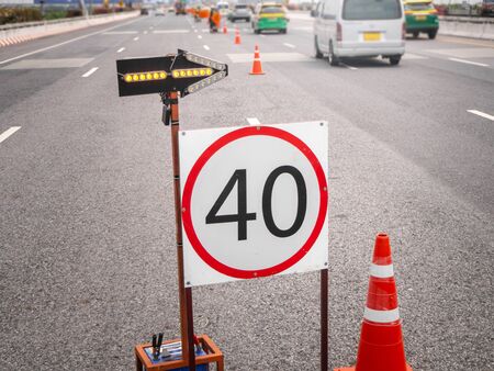 The signs repairs road and worker on the roadの写真素材