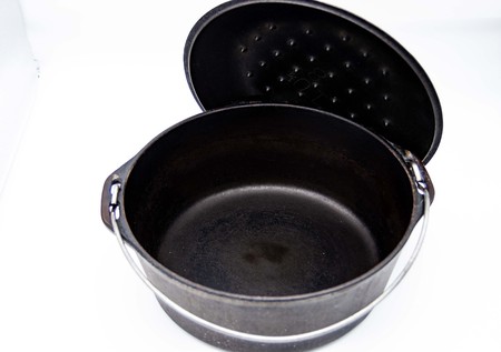 empty cast iron pot on white backgroundの写真素材