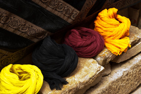 Turbans on a sandstone wall with a tapestry backgroundの写真素材