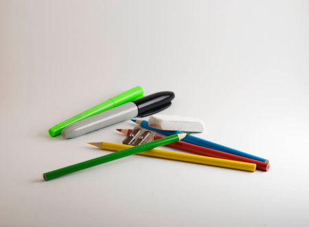 Pencil crayons, markers, eraser and sharpener on a white backgroundの写真素材