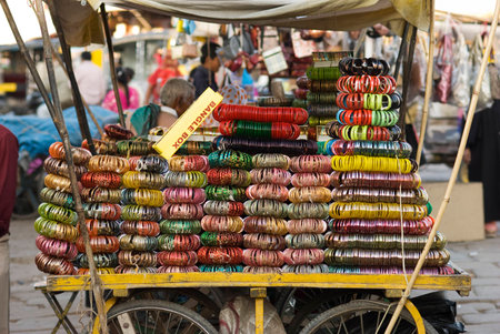 Variety of colorful bangle bracelets on a cartの写真素材