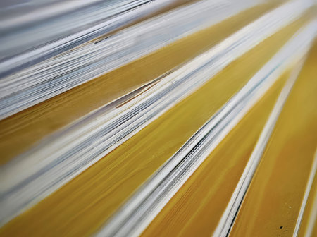 abstract background of yellow and white sheets of paper stacked in a rowの写真素材