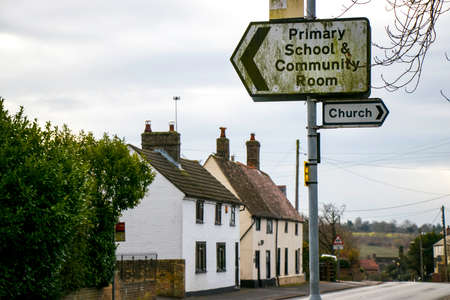 Primary school and church street signs in English villageの写真素材
