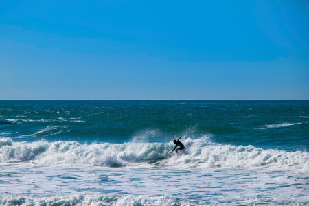 Surfer at Trebarwith Strand in Cornwall, England