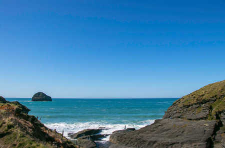 Beautiful Trebarwith Strand in Cornwall, England with aquamarine Atlantic ocean, rocks and clear...