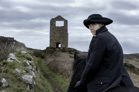 Handsome Male Horse Rider Regency 18th Century Poldark Costume with tin mine ruins and countryside in backgroundの写真素材