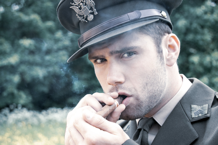 Handsome American Army officer in uniform smoking cigarの写真素材