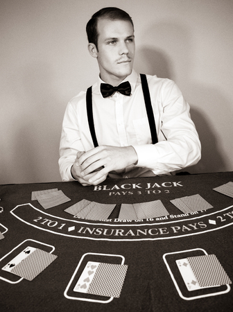 Croupier deals cards at game blackjack tableの写真素材