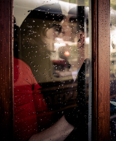 Sexy couple kissing and holding each other passionately in phone boxの写真素材