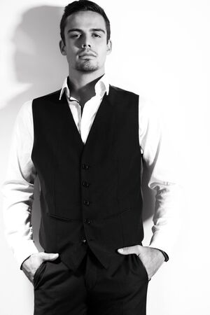 Portrait of handsome man with goatee looking at camera isolated against white wall.の写真素材