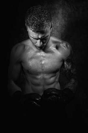 Portrait of young attractive shirtless muscular male boxer with defined absの写真素材