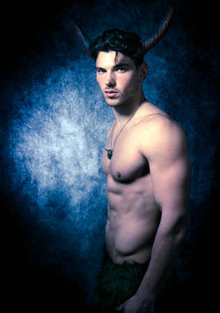 Sexy shirtless male devil with horns and muscular body showing pecs and absの写真素材