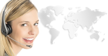 Close-up portrait of female customer service representative wearing headset with world map against white backgroundの写真素材