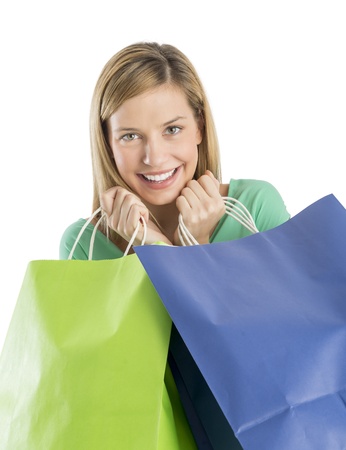 Portrait of cheerful young woman holding shopping bags isolated over white backgroundの写真素材