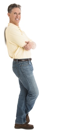 Side view portrait of happy man in casuals standing arms crossed over white backgroundの写真素材