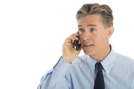 Mature businessman using smart phone isolated over white backgroundの写真素材