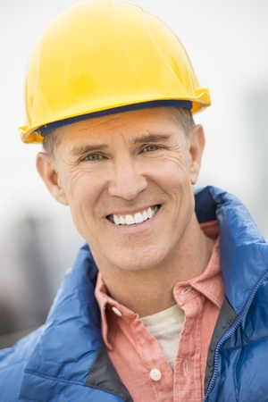 Close-up portrait of happy construction worker at siteの写真素材