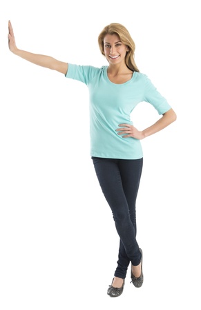 Front view portrait of beautiful young woman with hand on hip leaning over white backgroundの写真素材