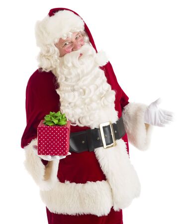 Portrait of Santa Claus gesturing while holding gift box against white backgroundの写真素材