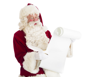 Santa Claus reading list isolated over white backgroundの写真素材