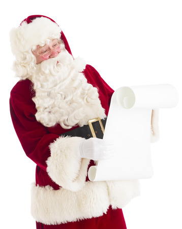 Santa Claus reading wish list while standing isolated against white backgroundの写真素材