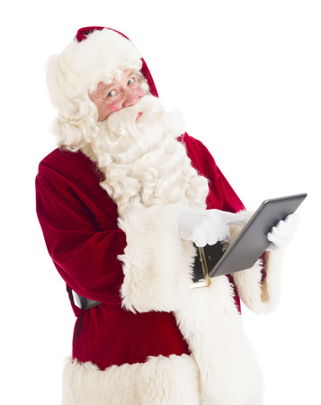 Portrait of Santa Claus using digital tablet against white backgroundの写真素材