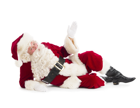 Portrait of Santa Claus gesturing while lying on floor isolated over white backgroundの写真素材