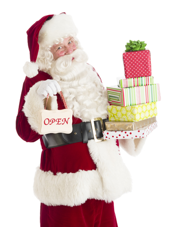 Portrait of Santa Claus with gifts and Open sign standing isolated over white backgroundの写真素材