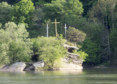 Three Crosses Adorn a rock in the riverの写真素材