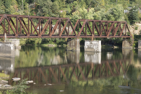 Reflection of an old iron railroad bridgeの写真素材