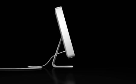 white flat computer on black backgroundの写真素材