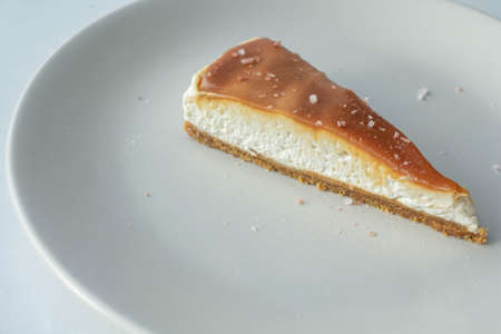 A slice of cheese cake with salted caramelの写真素材