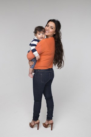 Brunette mother with her child on a white backgroundの写真素材