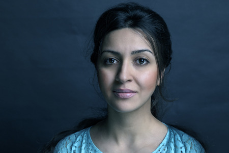 Girl posing in a studio on black backgroundの写真素材