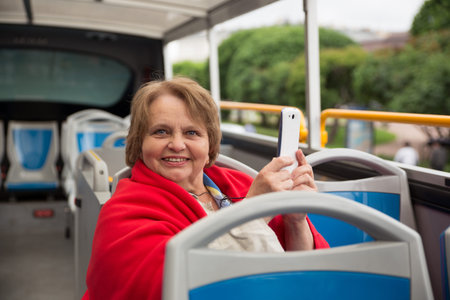 Smiling russian senior woman on a tour bus, Saint-Petersburg, Russia