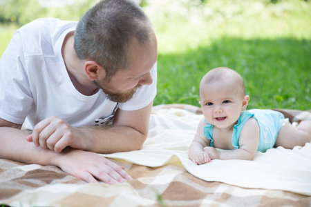 Baby girl crawling on the grass. Selective focus on her eyes.