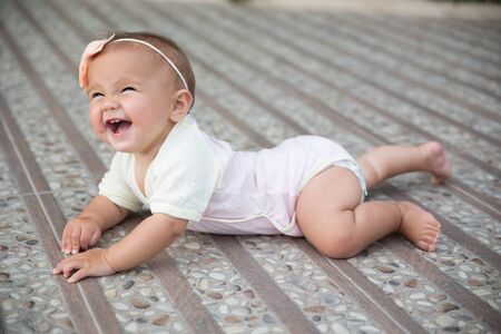 Baby girl crawling outsideの写真素材