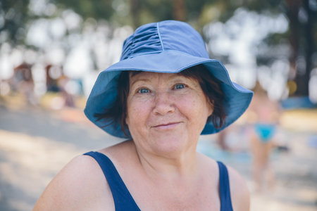 Senior woman wearing hat relaxed and happy outside