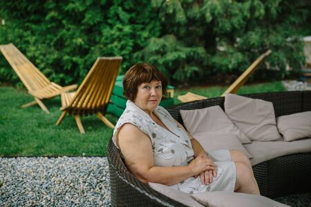 Senior woman relaxed in restaurant outsideの写真素材