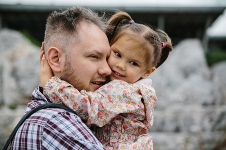 Emotional girl hugs her dad. Soft focus, closed portrait