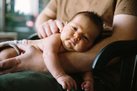 Sweet baby new-born sleeping on father handsの写真素材